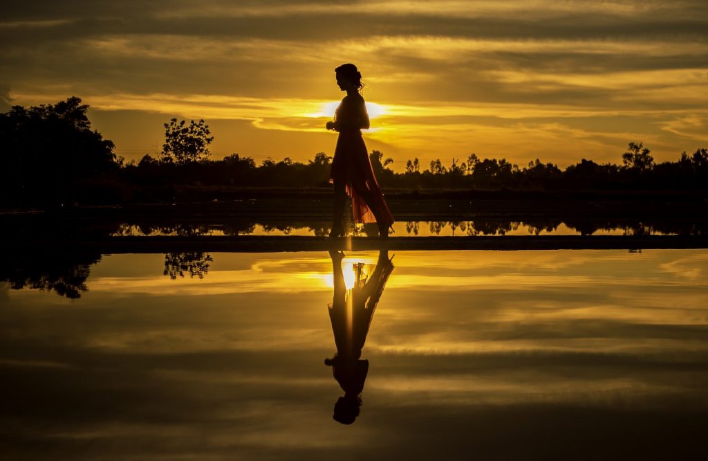 The answer Eyezak is looking for, is Shadow. This is a woman, on a beach, casting a shadow on water.